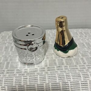 Silver ice bucket and gold top of champagne bottle salt and pepper shakers